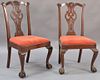 Pair of Chippendale mahogany side chairs with pierced carved backs and slip seats, set on cabriole legs ending in ball and cl