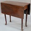 Mahogany Queen Anne diminutive drop leaf table, 18th century (one leg spliced). 
ht. 30in., top closed: 13" x 32", top open: 