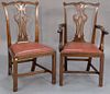 Set of ten Regency Chippendale style mahogany dining chairs with slip seat and stretcher base.