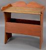 Primitive bucket bench with gallery top over open section on plain bootjack ends.  ht. 34in., wd. 33in., dp. 18 1/2in. Proven