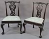 Pair of Chippendale mahogany side chairs having carved crest rail, open work back, and slip seat, all set on carved cabriole 