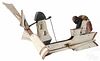 Two painted pine cut out whirligigs, mid 20th c., one of a mammy washing clothes, 19 1/2'' l., the ot