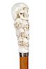 66. Stag Skull Cane- 20th Century- A high relief carved stag handle with approximately 13 skulls, the perfect number for a sk