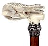 68. Alligator Dress Cane- Ca. 1930- A full length gator carved from walrus ivory with nice detail, ornate silver metal collar