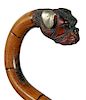 106. Tepliz Bulldog Cane- Ca. 1890- A carved bulldog head with silver overlaid ears, two color glass eyes, hard bamboo shaft 