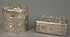 Two sterling silver repousse boxes including figural box and a Kirk & Sons floral round box. ht. 1 1/2in., lg. 3 1/2in. & ht.