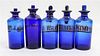 A Collection of Five Blue Glass Apothecary Bottles Height of tallest 7 1/2 inches.
