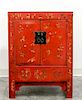 * A Chinese Red Lacquered Elmwood Cabinet