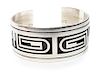 A Hopi Silver Overlay Bracelet, Andrew Saufkie (b. 1946) Length 5 7/8 x opening 1 x width 1 inches.