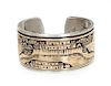 A Navajo Silver and 14 Karat Gold Pictorial Bracelet Length 5 3/4 x opening 3/4 x width 1 1/4 inches.