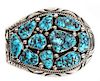 A Navajo Silver and Turquoise Belt Buckle, Orville Tsinnie (1943-2017) Height 3 x width 4 inches.