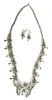 A Zuni Silver and Turquoise Petit Point Squash Blossom Necklace and Earrings, Eleanor Weeka (1928-2012) Length of necklace 22