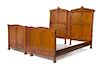 * Louis Majorelle, (French, 1859-1926), a bedroom set, comprising an armoire separated into two individual display cabinets, 