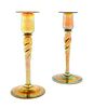 * Steuben, EARLY 20TH CENTURY, a pair of Aurene glass candlesticks, each of baluster form with twisted stem in gold iridescen