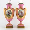Pair of Antique Sevres Style Porcelain Urn Lamps. Gilt hand painted scrolling on rose ground with mock figural handles, court