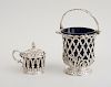 WILLIAM IV SILVER MUSTARD POT IN THE GOTHIC STYLE AND A VICTORIAN SILVER SUGAR BASKET WITH SWING HANDLE AND LATTICE BOWL
