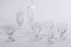 FIVE CLEAR GLASS GOBLETS ON SQUARE BASES AND TWO WHITE CASED GLASS VASES