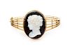 A Yellow Gold and Onyx Cameo Bangle Bracelet, 28.30 dwts.