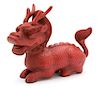A Chinese Carved Composite Red Lacquer Model of a Dragon Height 9 x width 13 x depth 5 inches.