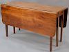 Federal mahogany table with drop leaves and six legs, four that swing, with line inlays, circa 1800. 
ht. 27 1/2in., top clos