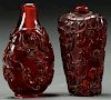 A PAIR OF CHINESE CARVED AMBER SNUFF BOTTLES