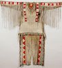 A SIOUX BEADED AND QUILLED HIDE MAN’S WAR SHIRT