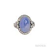Platinum, Star Sapphire, and Diamond Ring, centering a cabochon measuring 15.65 x 10.85 x 12.40 mm, framed by marquise- and s