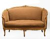 A CIRCA 1900 LOUIS XVI CARVED AND GILDED SOFA