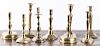Nine brass and bell metal candlesticks