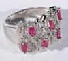 14 karat white gold cocktail ring set with six marquis cut red stones, all surrounded by diamonds. size 8