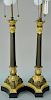Pair of bronze and gilt bronze table lamps having two lights each on gilt bronze corinthian over three columns, set on scroll