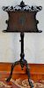Mahogany music stand with pierce carved top and sheet music holder on carved pedestal on tripod base (adjustable height). Pro