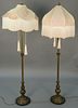 Pair of metal floor lamps with custom silk shades.  ht. 67in., dia. 20in.  Provenance: Property from the Estate of Frank Perr