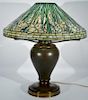 Tiffany Studios Daffodil table lamp having leaded Favrile glass shade with cascading daffodils on bronze oil converted to ele