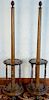 Pair of oak round revolving cue stick holders, each with center column with pineapple top, twelve cue holders each set on rou