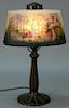 Reverse painted boudoir lamp with oval fluted shade painted with romantic scene. ht. 15in., shade: 5 1/2" x 9" Provenance: Pr