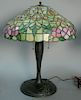 Leaded glass table lamp on metal base. ht. 23in., dia. 19in. Provenance: Property from the Estate of Frank Perrotti Jr. of Ha