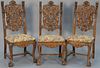 Set of ten oak dining chairs having highly carved backs with face and scroll designs and wing female figures flanked by carve