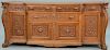Large Victorian oak sideboard having foliate carved drawers and doors flanked by carved lion heads on paw feet
