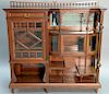 Pair of Aesthetic movement mahogany curio cabinets having one drawer, two doors, and various shelves