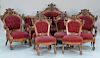 Seven piece walnut and burl walnut parlor set to include sofa, two armchairs, and four side chairs all with Jenny Lind face,