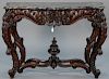 Victorian walnut hall table having cookie corner marble top on carved base with cabriole legs and center stretchers and finia