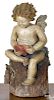 Painted redware figure of cupid atop a stump