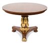A Regency Mahogany and Gilt Decorated Center Table Height 28 1/2 x diameter 42 inches.