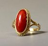 A FINE 18K GOLD RED CORAL RING