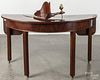 George III mahogany demilune table, ca. 1780, the demilune cutout with a lazy susan insert, 29'' h.