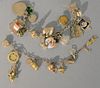Two gold charm bracelets with several gold charms on each. 65.5 grams