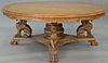 Reproduction oak round table with carved top and carved griffin base, ht. 31in., dia. 80in. Provenance: Property from the Est