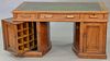 Wooton desk having leather top surrounded by burl walnut on double revolving pedestal base, ht. 31in., top. 32" x 59"