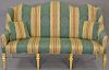 Upholstered love seat with custom upholstery on gilt legs, ht. 42in., wd. 66in.